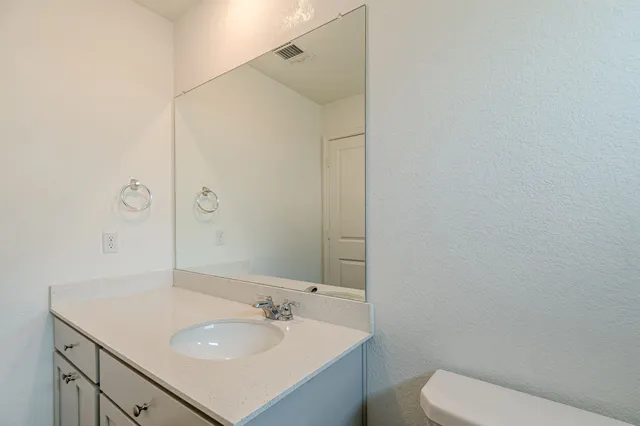 a bathroom with a sink toilet and vanity