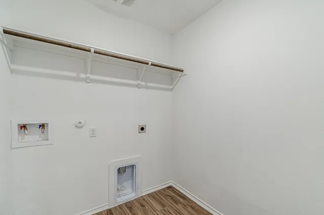 a view of storage and utility room with wooden floor