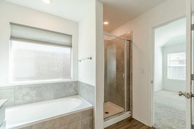 a bathroom with a bathtub and a shower