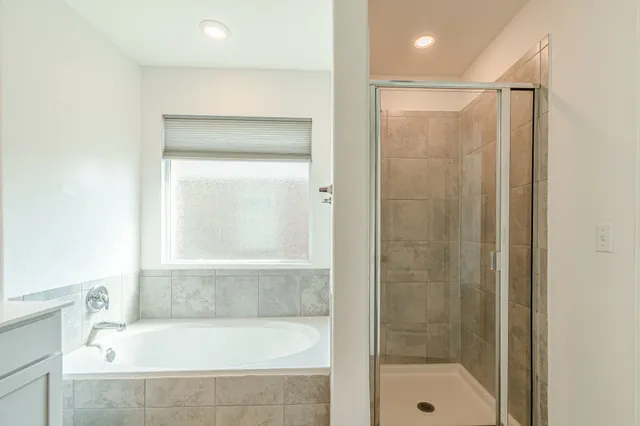 a bathroom with a bathtub and a shower