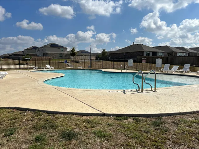 a view of a swimming pool with an outdoor seating