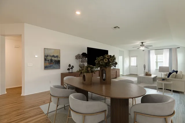 a dining room with furniture and wooden floor