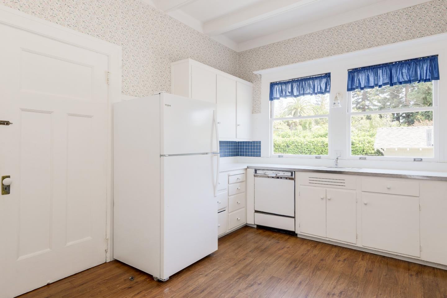 16 Maple Avenue Atherton, CA 94027 - Photo 14 of 25 a kitchen with white cabinets and white appliances