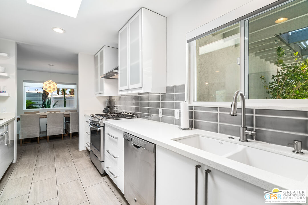 73428 Little Bend Trail Palm Desert, CA 92260 - Photo 19 of 46 a kitchen with a sink stove top oven and cabinets