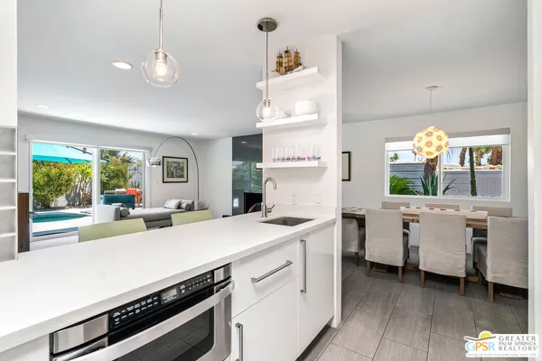 a kitchen that has a lot of cabinets in it and wooden floor