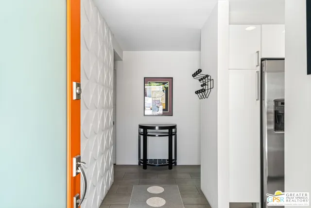 a view of an entryway with wooden floor and a livingroom