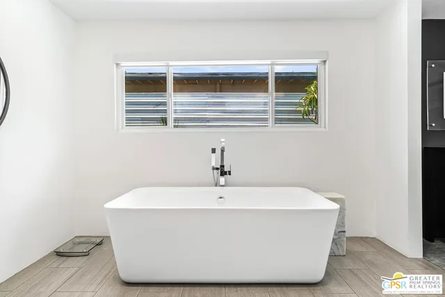 a white bath tub sitting in a bathroom