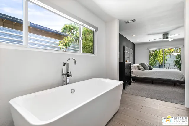 a en suite bathroom with a bathtub and window