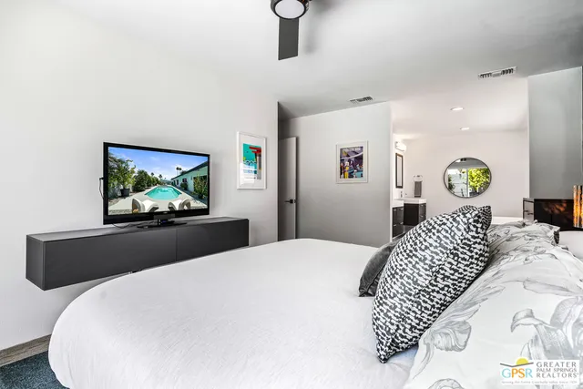 a bedroom with a bed and ceiling fan