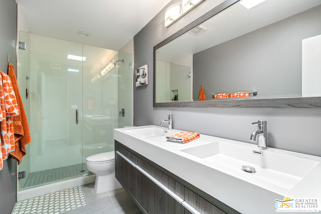 73428 Little Bend Trail Palm Desert, CA 92260 - Photo 35 of 46 a bathroom with a sink a toilet and a large mirror