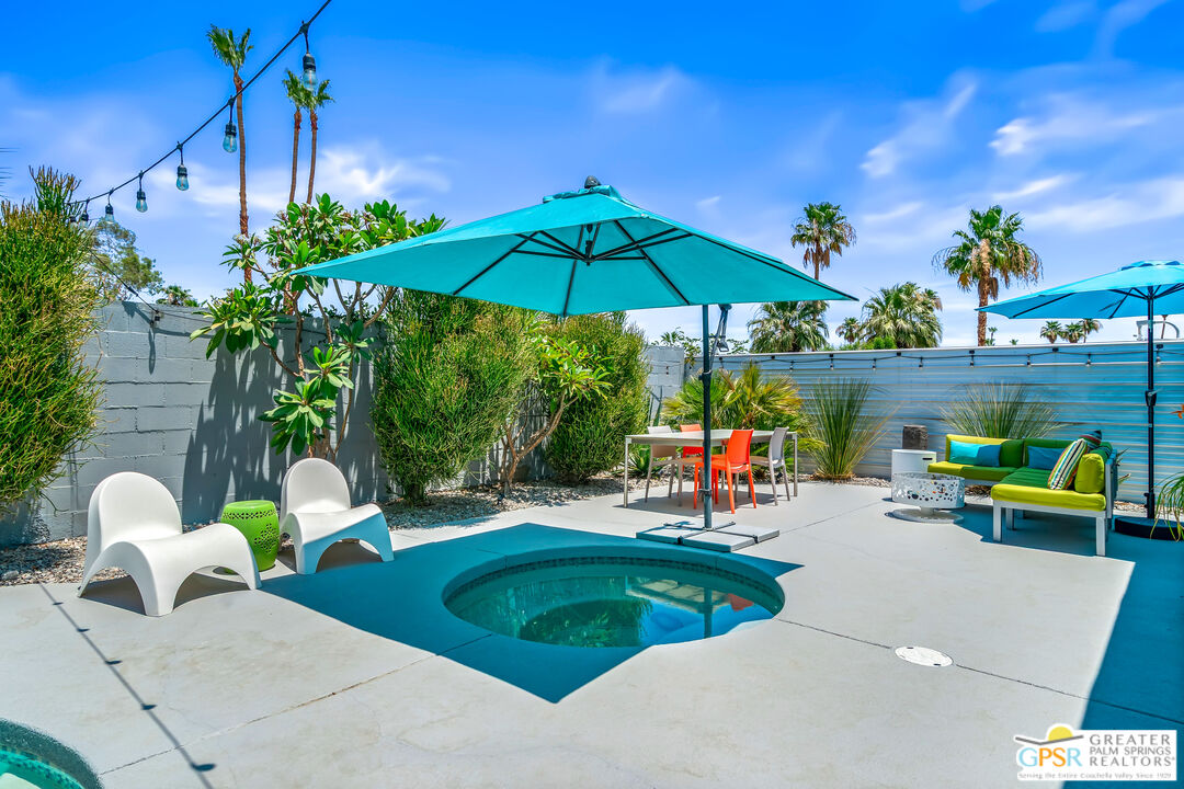 73428 Little Bend Trail Palm Desert, CA 92260 - Photo 42 of 46 a view of a chairs and table under an umbrella in the patio