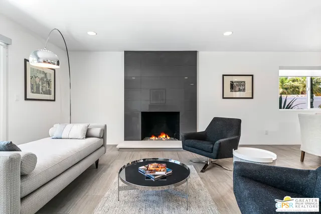 a living room with furniture and a fireplace
