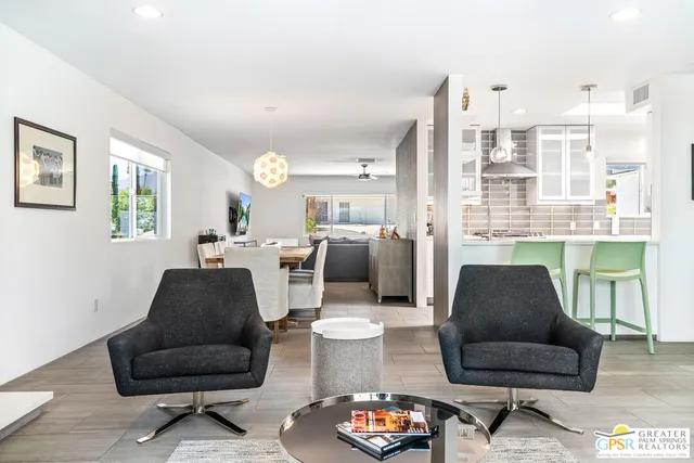 a living room with furniture and a chair