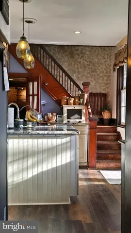 a front view of a house with swimming pool and outdoor seating
