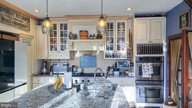 a dining room with a fireplace a clock on wall and a table