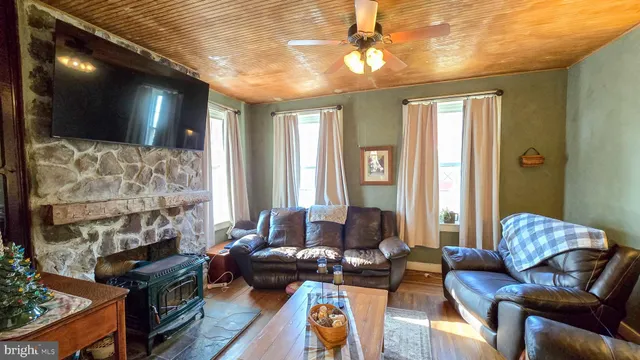 a view of closet with clothes and shoes