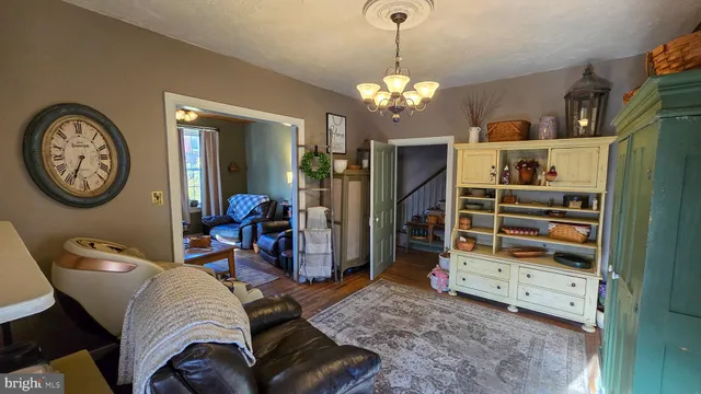 a living room with furniture and a chandelier