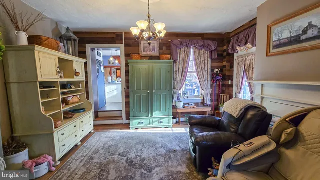 a living room with furniture a fireplace and a chandelier