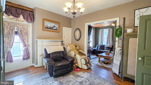 a bedroom with furniture and a wooden floor