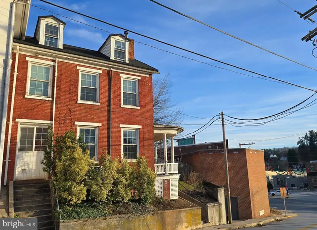 a front view of a residential apartment building with a yard