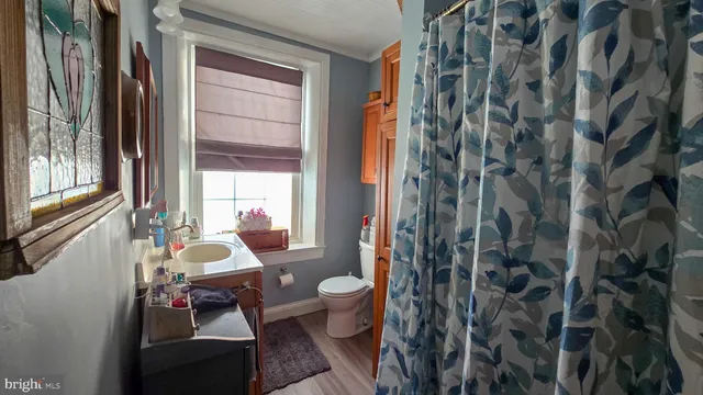 a view of an entryway with wooden floor and windows