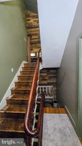 a living room with furniture a rug and a floor to ceiling window