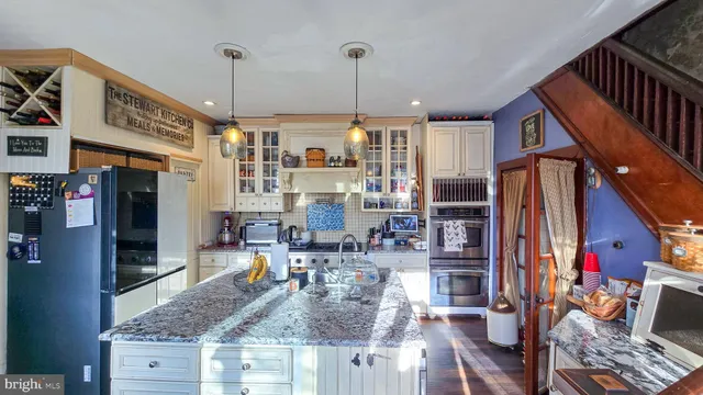 a kitchen view of living room and utility room