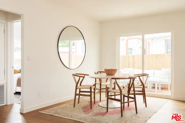 a view of a dining room with furniture and a window