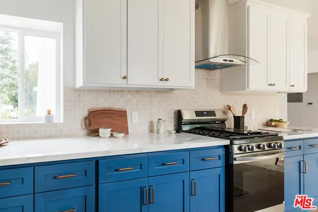 a kitchen with stainless steel appliances granite countertop a sink stove and cabinets