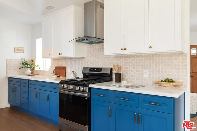 a kitchen with stainless steel appliances granite countertop a sink a stove and cabinets