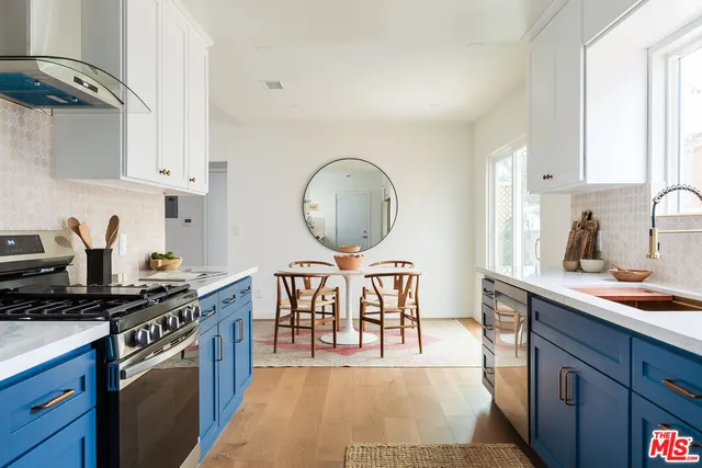 a kitchen with a stove a sink and a cabinets