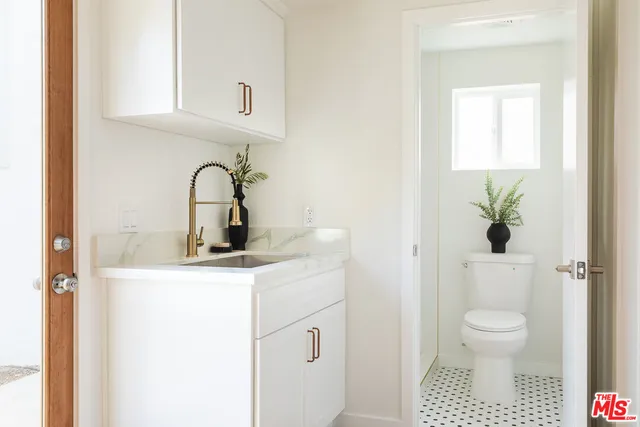 a bathroom with a toilet a sink and a window