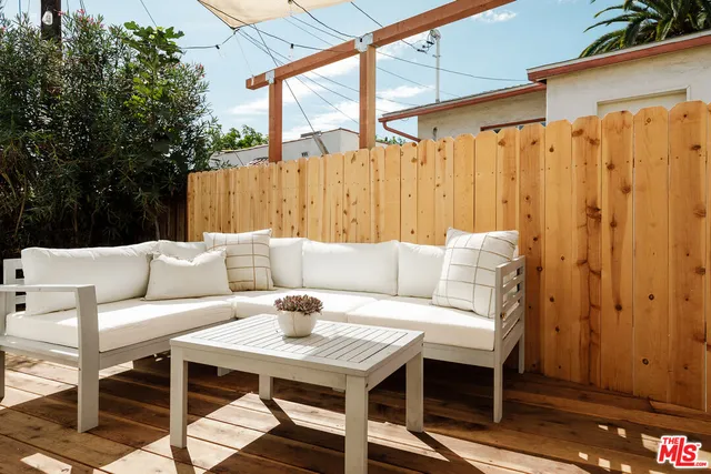 a roof deck with a table and chairs