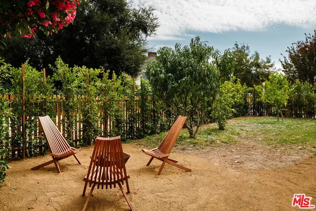 a view of a patio with a table and chairs
