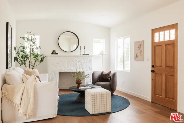 a living room with furniture a fireplace and a table