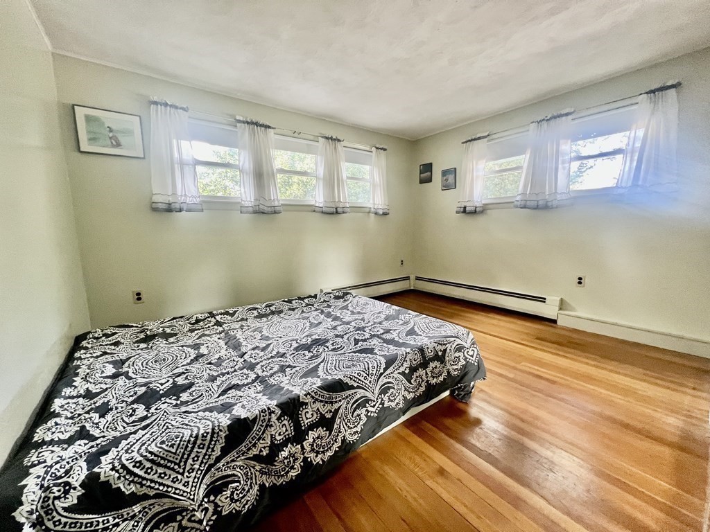 11 Tower Road Ashland, MA 01721 - Photo 13 of 31 a bedroom with a bed and wooden floor