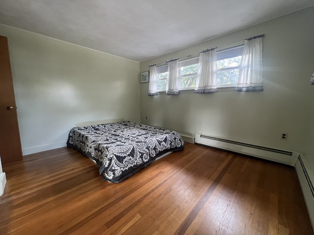 11 Tower Road Ashland, MA 01721 - Photo 14 of 31 a bedroom with a bed and wooden floor