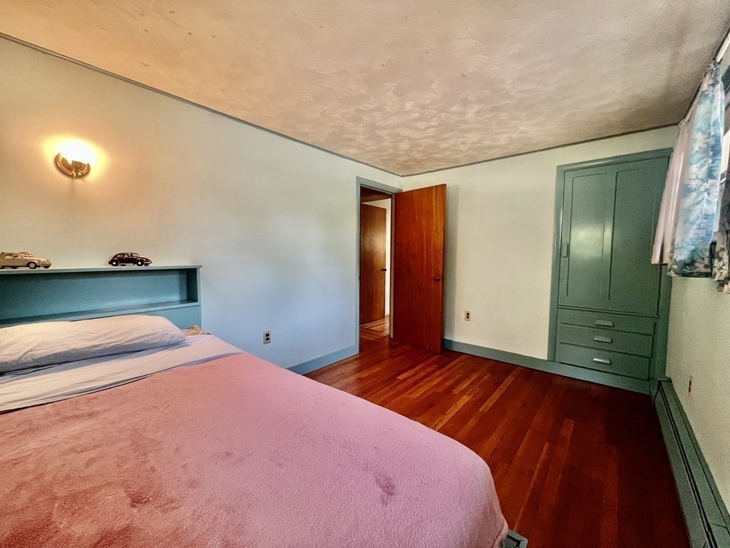 11 Tower Road Ashland, MA 01721 - Photo 16 of 31 a bedroom with a bed and a painting on the wall