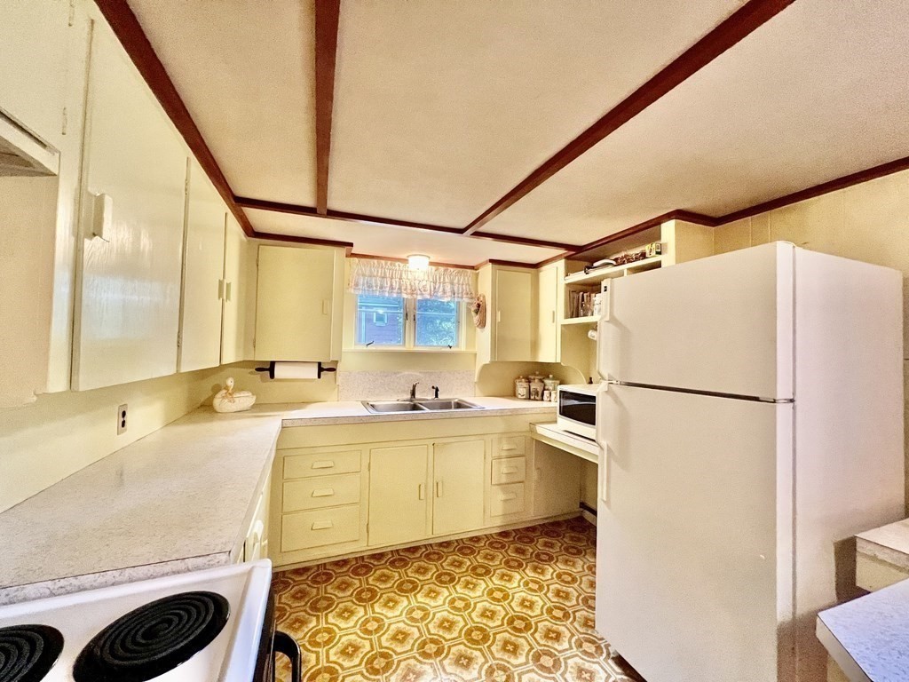 11 Tower Road Ashland, MA 01721 - Photo 20 of 31 a kitchen with a refrigerator and a sink