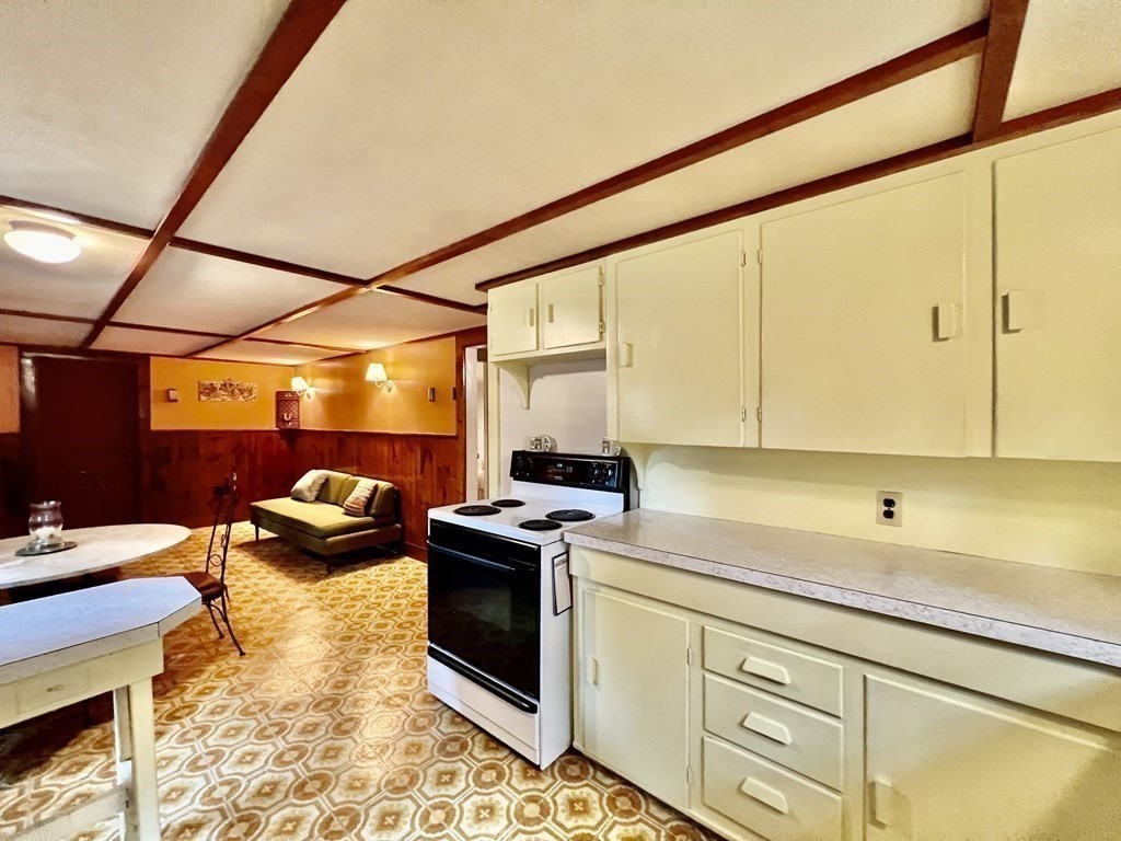 11 Tower Road Ashland, MA 01721 - Photo 21 of 31 a kitchen with a sink and a stove next to a window
