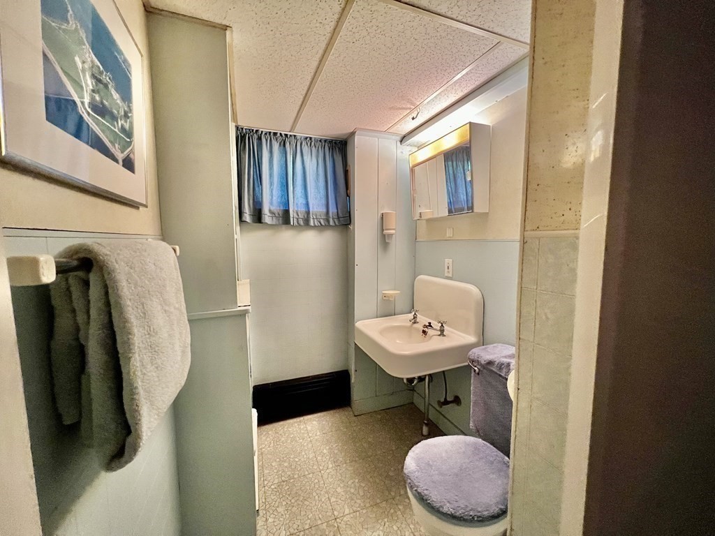 11 Tower Road Ashland, MA 01721 - Photo 23 of 31 a bathroom with a sink toilet and a mirror
