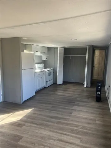 a room with a wooden floor and furniture