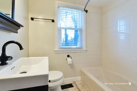 a bathroom with a sink a toilet and a bathtub