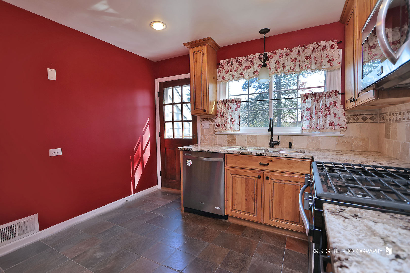275 Harding Street Grayslake, IL 60030 - Photo 10 of 25 a kitchen with stainless steel appliances granite countertop a stove a sink and a microwave