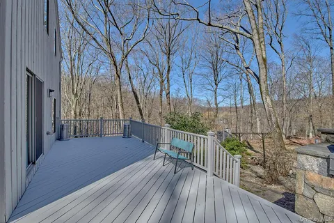 a balcony with wooden floor and fence
