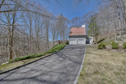 a view of house with backyard and a small cabin