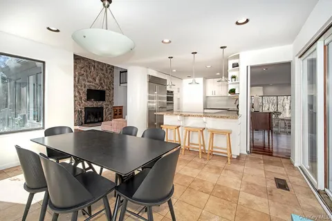 a view of a dining room and livingroom with furniture wooden floor and a rug
