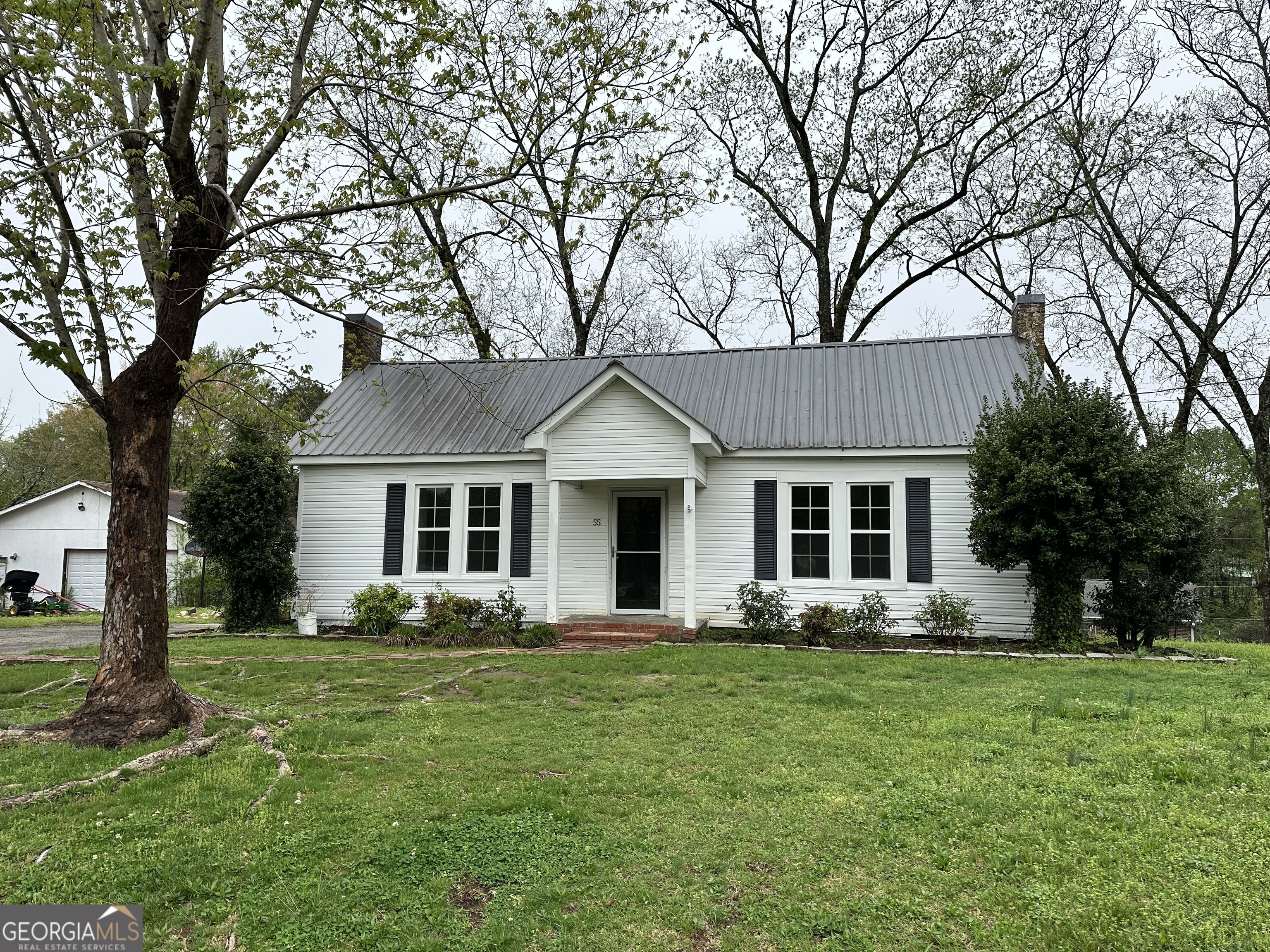 a front view of house with yard and green space