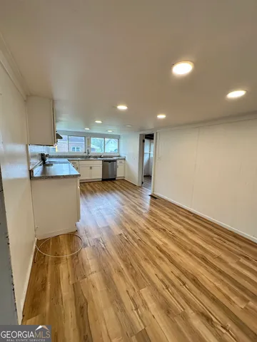 a view of kitchen with cabinets and wooden floor