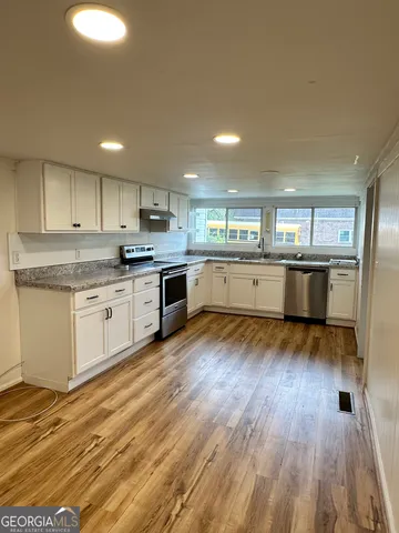 a kitchen with stainless steel appliances granite countertop a stove and a sink
